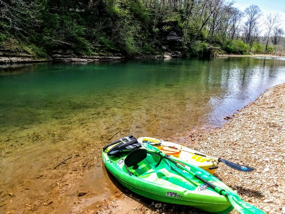 Piney river with Kayaks on the bank